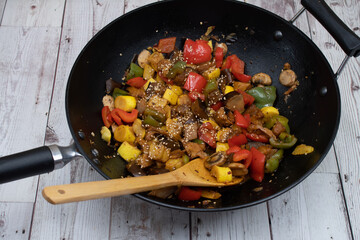 Korean vegetables and seitan stir fry served in wok