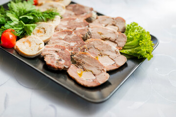 slicing pork and beef meat on a plate