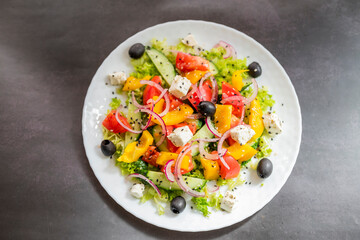 Greek salad dish with feta cheese and olives with vegetables for a healthy meal in a restaurant