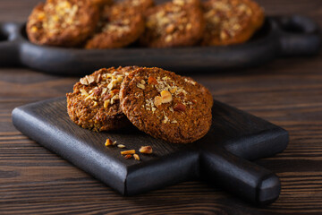 Oatmeal cookies with quinoa and carrots in a wooden board. Sugar, gluten and lactose free and vegan.