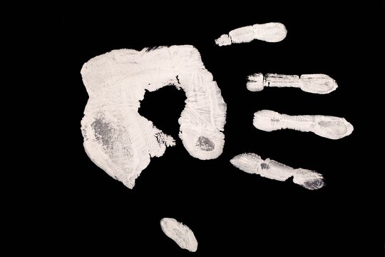 White Handprint on Black Background