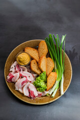 Ukrainian food. plate of appetizer with chopped salo lard with green onions and mustard with bread