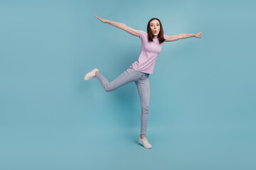 Fototapeta na wymiar Full size photo of excited girl enjoy raise hands imagine she swallow fly air sky isolated over teal color background
