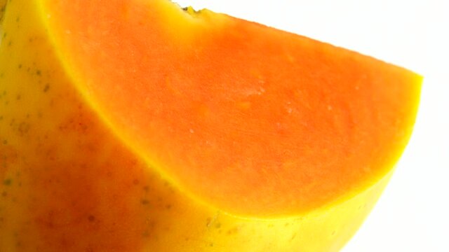 4K Half ripe papaya fruit with seeds. Fragrant tropical fruit pulp. Sweet fisolated resh papaw, raw vegan food isolated on white background