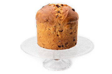 Panettone - Italian Christmas cake from Milan, prepared to celebrate Christmas and New Year, on raised glass tray, isolated on white