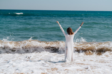 Woman in white dress freedom walk on ocean island