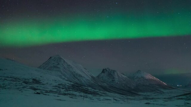 Northern lights known as aurora borealis over the arctic landscape in Norway. High quality time lapse footage. High quality 4k footage
