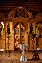 Fototapeta premium Holy water font for the baptism of children. The rite of initiation into the faith in the Christian temple. Church services - Liturgy of the baptism of children. Christian religious ceremony.