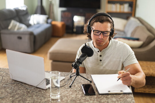 Caucasian disabled man recording podcast using microphone at home