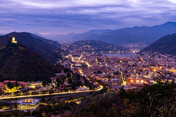  The city of Como, and the lake, photographed after sunset, with the mountains of Brunate, Castel...
