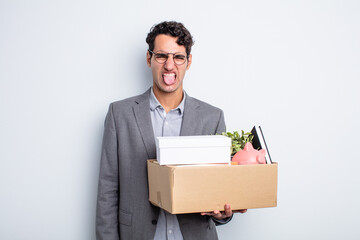young handsome man feeling disgusted and irritated and tongue out dismissal concept