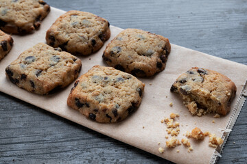 Cookies with dark chocolate chips on rustic background