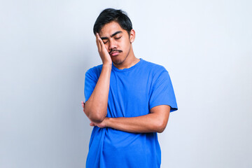 Young asian man wearing casual shirt thinking looking tired and bored