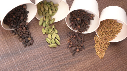 Collection of indian Spices and herbs. Food and cuisine ingredients on wooden background.