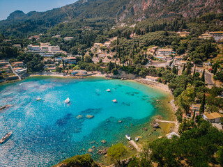 Aerial view of Paleokastritsa bay on a sunny day. Bay with beautiful turquoise water and boats.