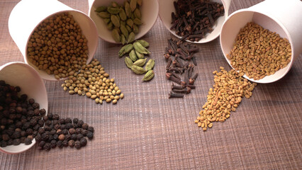 Collection of indian Spices and herbs. Food and cuisine ingredients on wooden background.