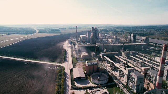 Cement plant with pipes. Сement production process and Industrial solution. factory with smoke pipe. Chimney smokestack emission. Poor environment. Ecology concept, air and environmental pollution.