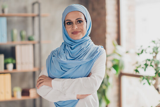 Photo of young arab business woman confident folded hands eyewear chief executive smart office veil indoors