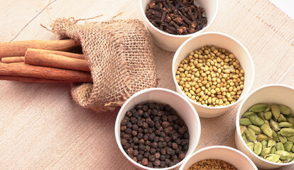 Collection of indian Spices and herbs. Food and cuisine ingredients on wooden background.