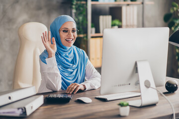 Photo of optimistic young arabic modern teacher lady say laptop wear eyewear headscarf shirt...