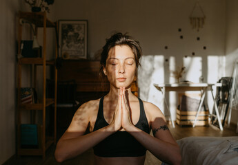 woman preparing for yoga at home