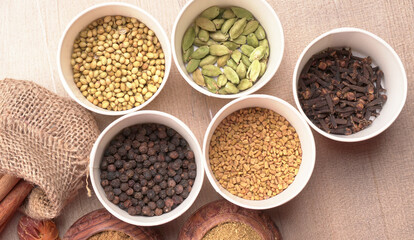 Collection of indian Spices and herbs. Food and cuisine ingredients on wooden background.