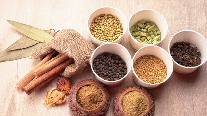 Collection of indian Spices and herbs. Food and cuisine ingredients on wooden background.