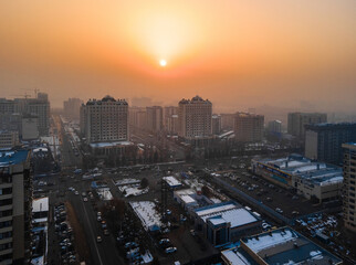 Sun shining through smog over southern Bishkek, Kyrgyzstan