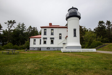 Fototapeta na wymiar Whidbey Island, Washington, USA - May 23 2021: Admiralty Head Lighthouse at Fort Casey State Park in Washington during summer.