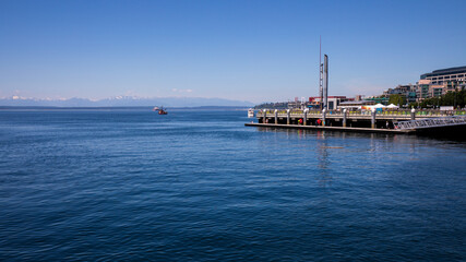 Seattle, Washington, USA - June 4 2021: Olympic National Park skyline from Seattle in summer. View from Seattle Aquarium.