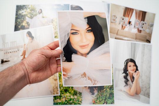 printed on paper photos of a beautiful brunette bride. 