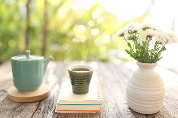 Old vintage ceramic cup and tea pot with white chrysanthemum vase