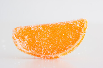 Vibrant sliced candied citrus fruits macro close up shot. Isolated on white, no people