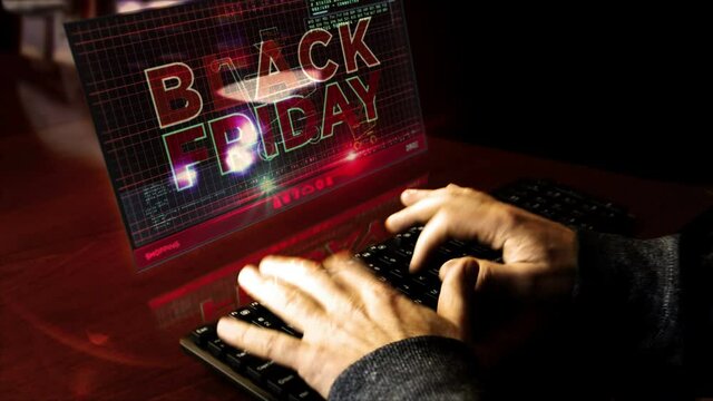 Hacker typing on the keyboard with Black Friday on virtual display on desk. Big sale, hot deal, shopping and special offer abstract concept.
