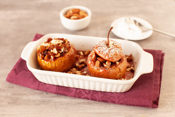 Obraz na płótnie Canvas Baked winter apples with raisins, almonds and honey
