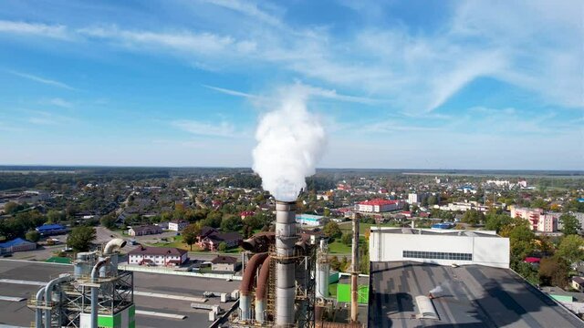 Smoke tower of industrial factory. Chimney smokestack emission.Refinery plant with pipes. Plant with smoke frow pipe and environmental pollution. Ecology concept and poor environment.