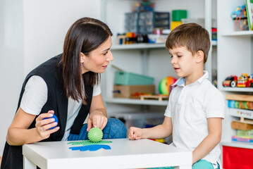 A woman speech therapist deals with the child and teaches him the correct pronunciation and...
