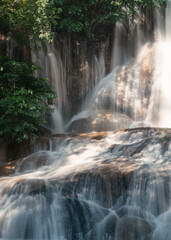 Fototapeta na wymiar Sai Yok Noi waterfall flowing on limestone in tropical rainforest at national park