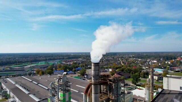 Smoke tower of industrial factory. Chimney smokestack emission.Refinery plant with pipes. Plant with smoke frow pipe and environmental pollution. Ecology concept and poor environment.