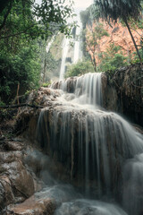 Fototapeta premium Erawan waterfall 7th floor with water flowing in tropical rainforest at national park