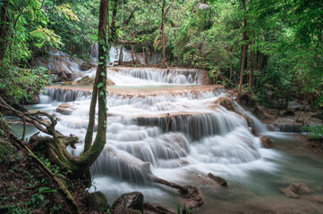 Beautiful Erawan waterfall flowing in tropical rainforest at national park