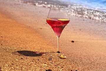 Wine glass with a cocktail by the sea.