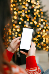 christmas mockup with space for text. christmas advertising, app template. hands holding phone with...
