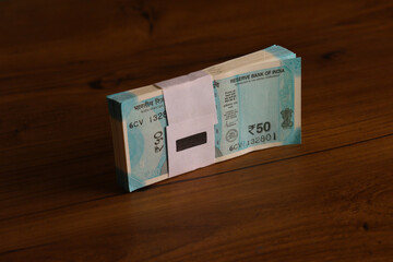Indian Currency 50 Rupees Note On Wooden Table