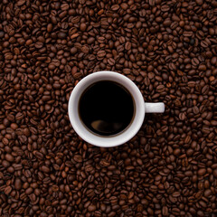White Cup  full of coffee. With a lots of beans around. Coffee background.