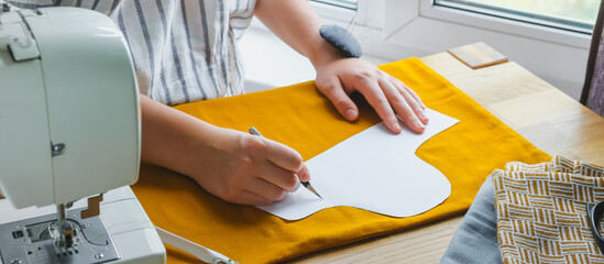 Sewing. Recycling Made by hand from home. sewing machine project quarantine, lockdown. home sewing,Hobby, meditation,zero waste,recycling. Girl sews clothes home sewing machine, ecology zero waste