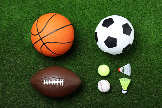 Set of different sport balls and shuttlecocks on green grass, flat lay © New Africa