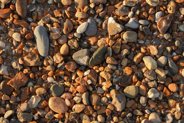 Colorful stones on the beach along the water