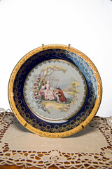 Artistic fine porcelain dish painted with a scene of a flirting couple of the 1800s 