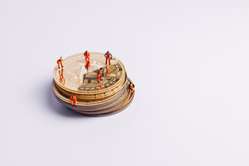 Miniature miner people working on pile of golden bitcoins on white background. Creative cryptocurrency or blockchain mining concept. Financial market, digital gold money and stock business banner.